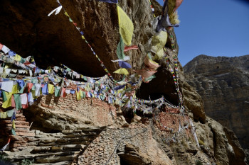 Drapeaux a priéres devant une grotte sacrée Sur le site d’ARTactif