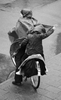 Œuvre contemporaine nommée « Mother and kid biking in rain », Réalisée par NORA